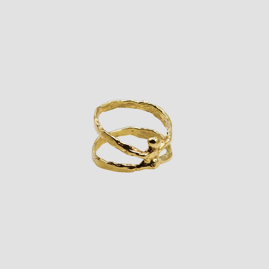Gold ring on a light gray background