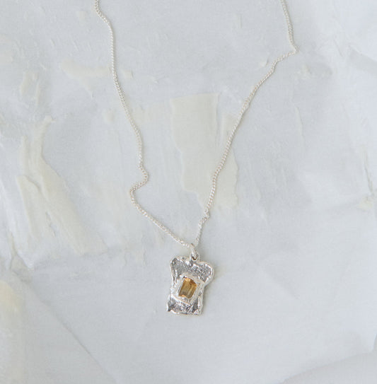 bread and butter silver pendant on necklace