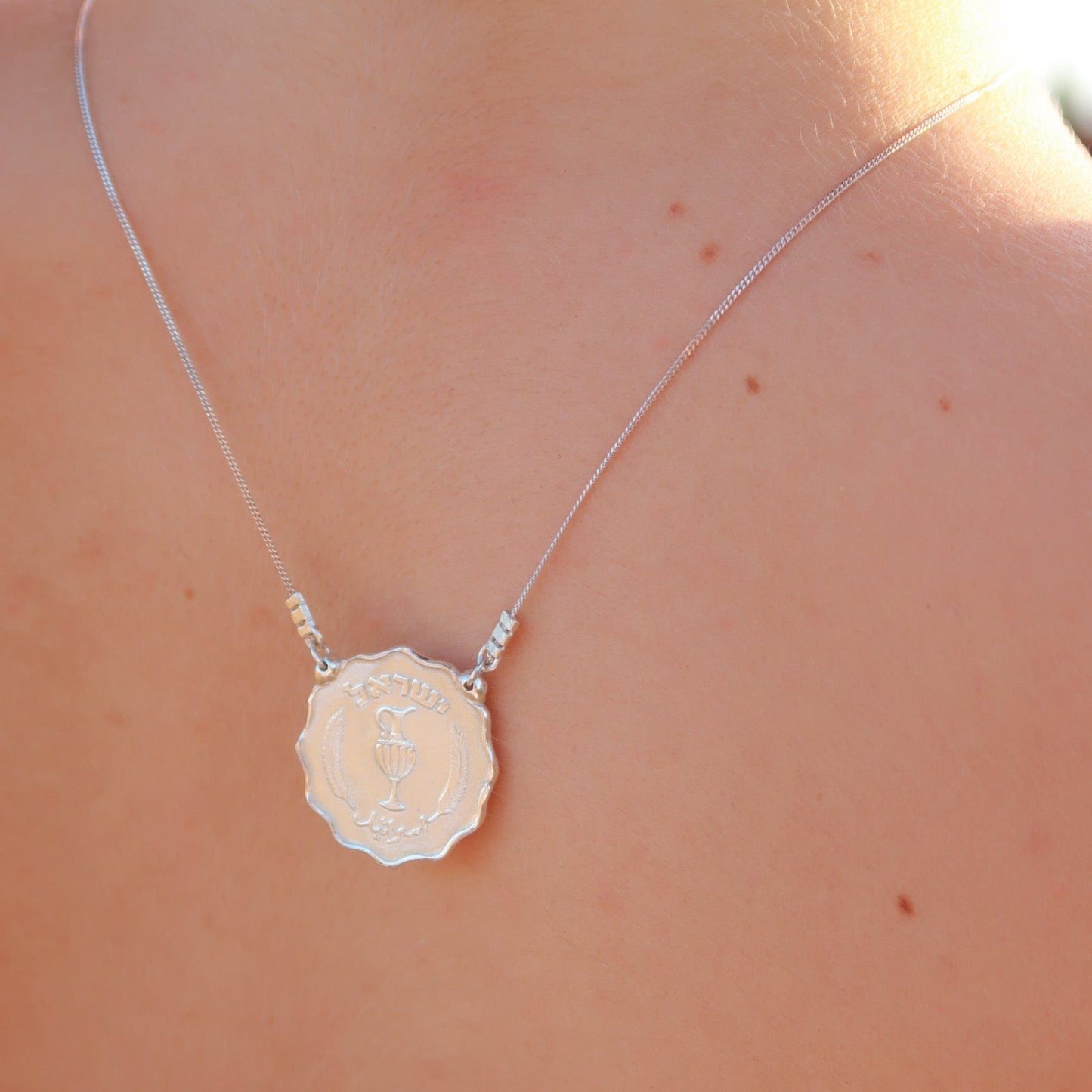 Necklace with a floral pendant on a person's back