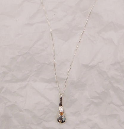 Necklace with a pendant on a textured light gray background