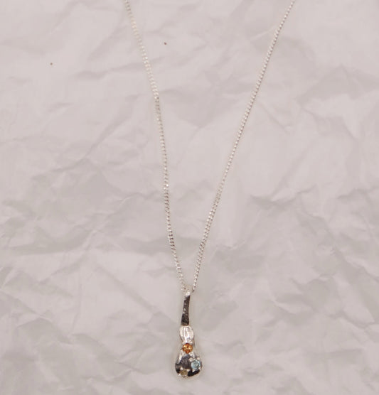 Necklace with a pendant on a textured light gray background