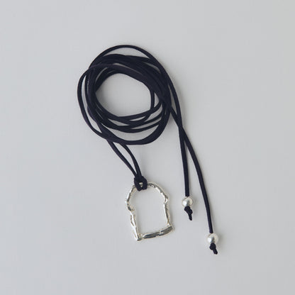 Necklace with a silver pendant on a gray background