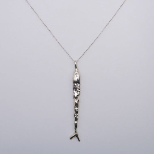 Silver necklace with a fish pendant in silver  on a light gray background
