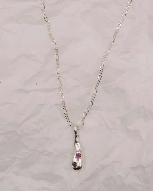 Silver necklace with an embedded pendant on a light gray background