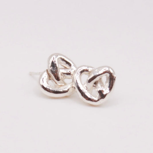 Pair of silver heart-shaped earrings on a light gray background