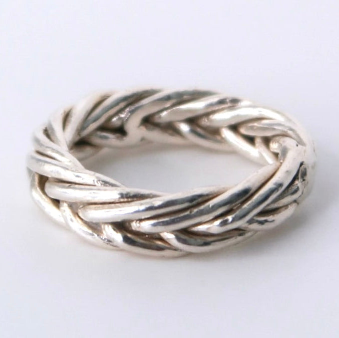 Silver braided ring on a white background