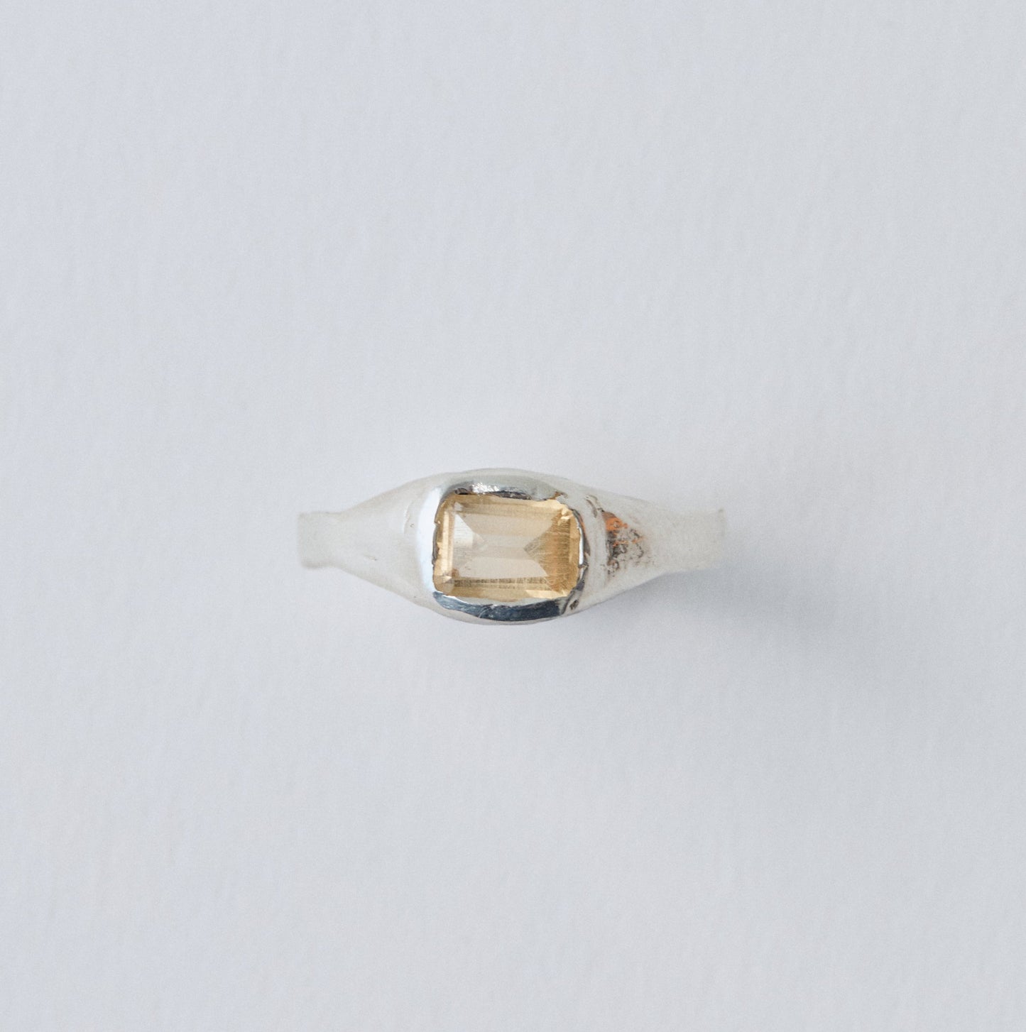 Ring with a gemstone on a light gray background
