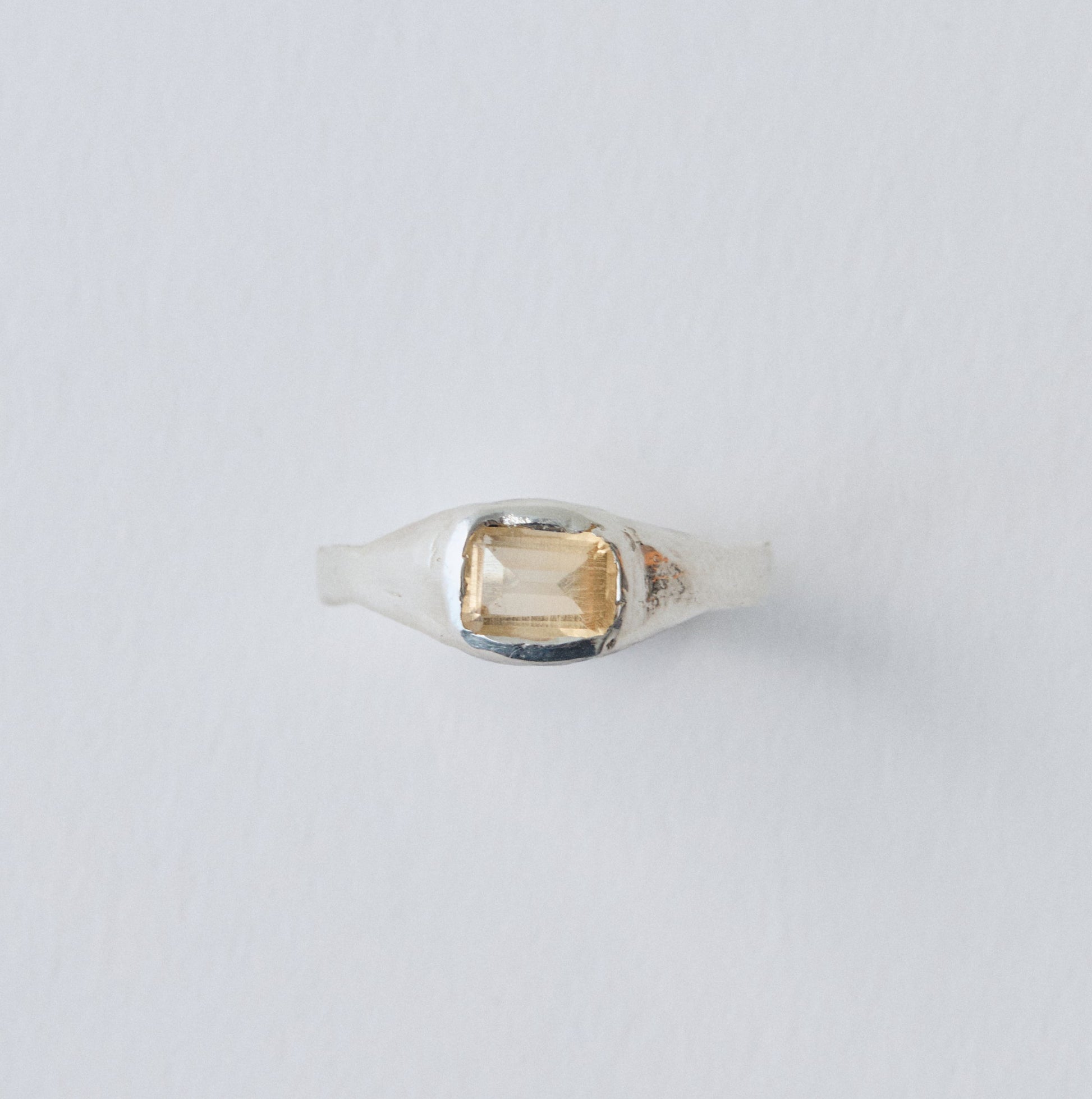 Ring with a gemstone on a light gray background