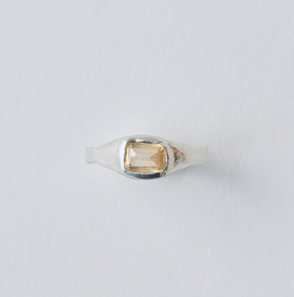 Ring with a gemstone on a light gray background