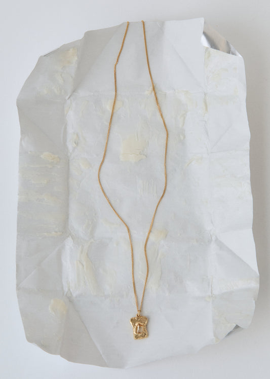 Gold necklace on a butter wrap