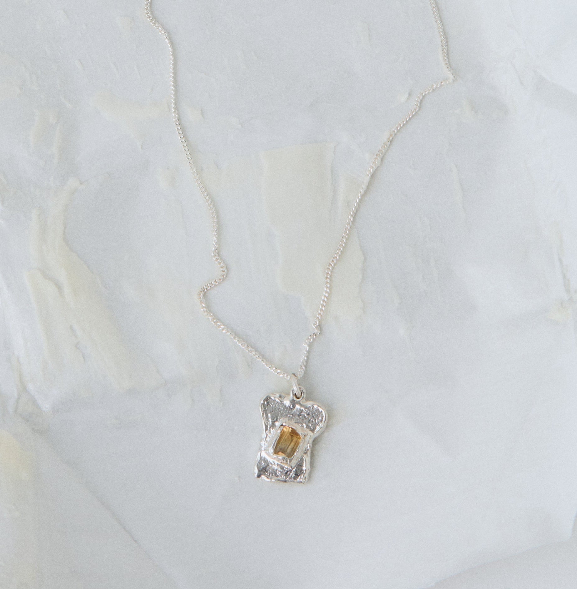 bread and butter silver pendant on necklace 