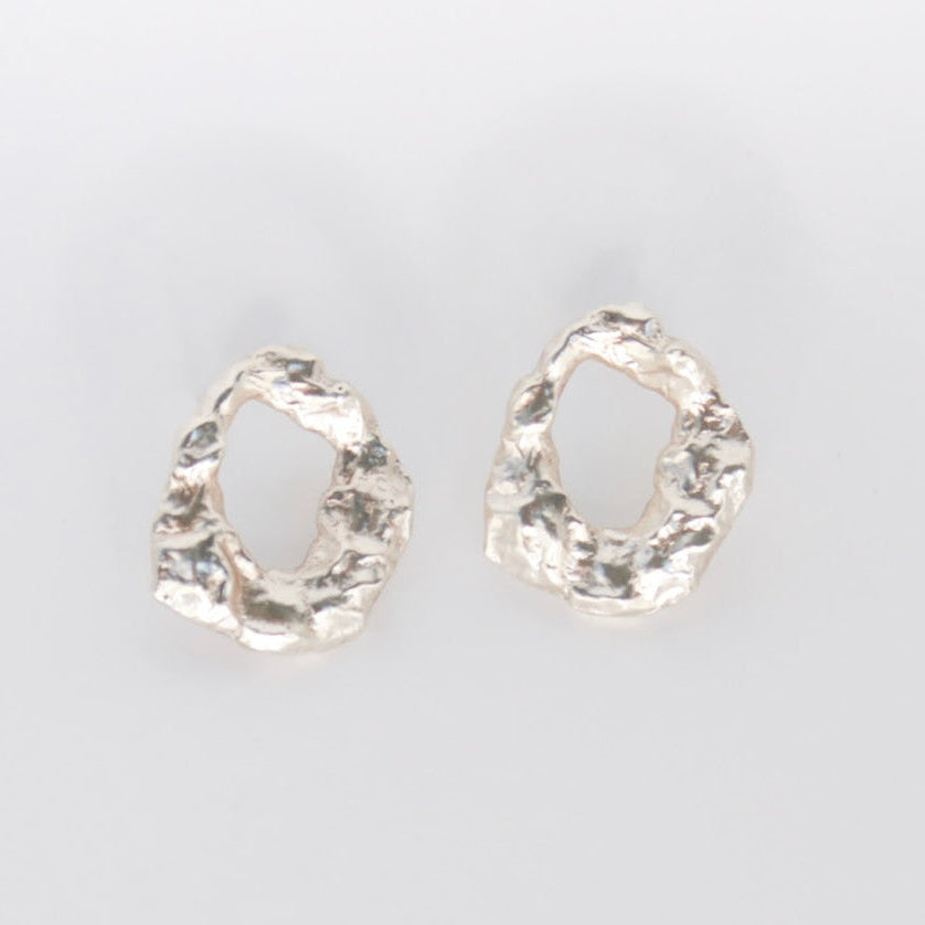 Pair of golem earrings on a light gray background