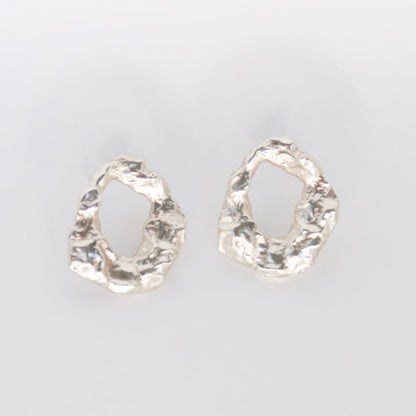 Pair of golem earrings on a light gray background