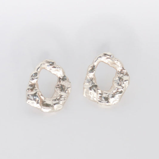Pair of golem earrings on a light gray background