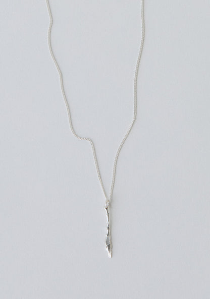 Silver necklace with a knife pendant on a light gray background