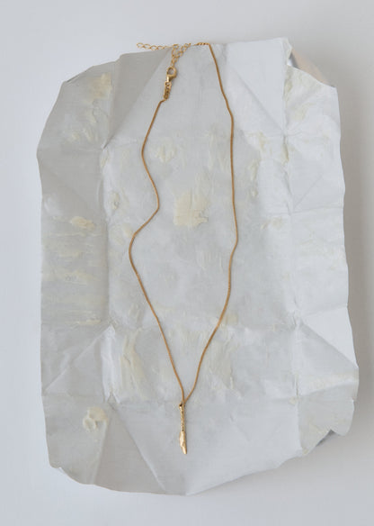 Gold necklace with a knife pendant