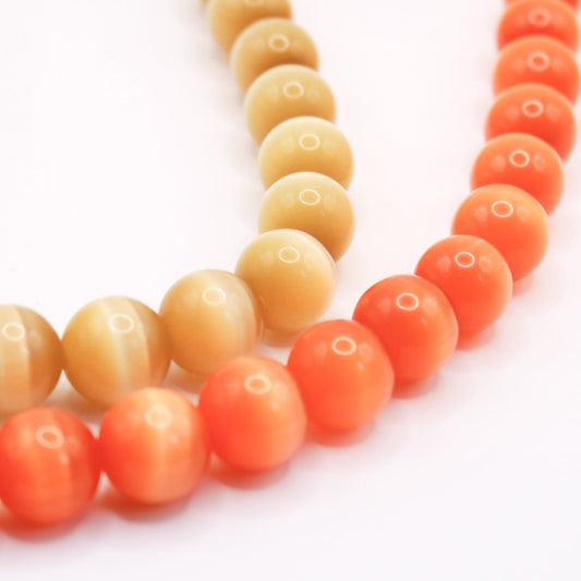 Necklace with orange and yellow beads on a white background