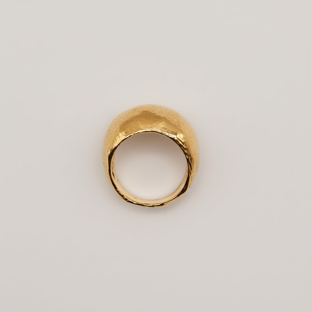 Gold ring on a light pink background
