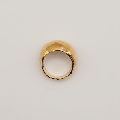 Gold ring on a light pink background