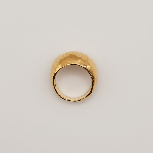 Gold ring on a light pink background