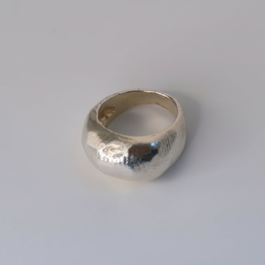 Silver ring on a light gray background