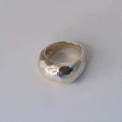 Silver ring on a light gray background